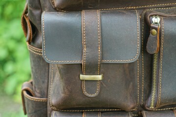 part of a leather brown trendy backpack with durable fittings and closed pockets