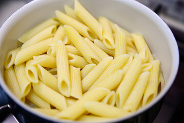 Fresh tasty pasta in pot, closeup view