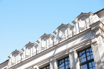 Beautiful old building against blue sky, low angle view. Space for text