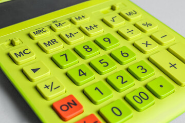 Closeup view of green calculator on light background