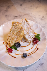 napoleon cake with berries. serving dessert in a restaurant