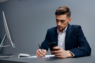 businessmen business conversation on the phone works in front of a computer Gray background