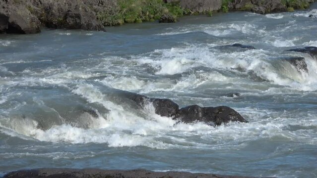 Fantastic landscape with flowing rivers and streams with rocks and grass in Iceland.