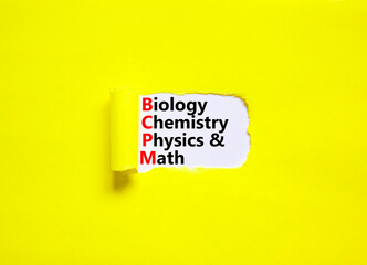 BCPM biology chemistry physics math symbol. Concept words BCPM biology chemistry physics math on white paper on beautiful yellow background. Business BCPM biology chemistry physics math concept.