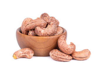 Cashew nuts in shell in wooden bowl, isolated on white background. Roasted and salted cashew nuts.