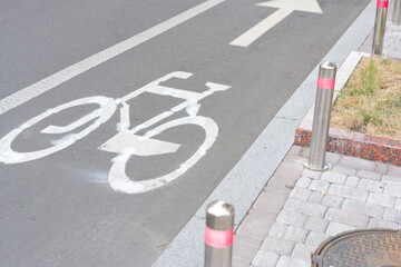 Road sign bicycle path with the sign is drawn on the asphalt. Sidewalk. Day. Commute. Arrow. Journey. Riding. Icon. Pathway. Cycling. Lifestyle. Roadsign. Pavement. Town. Symbol. Urban