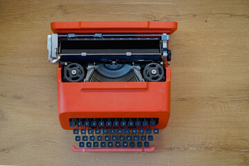 Above view of red vintage Olivetti typewriter. 
