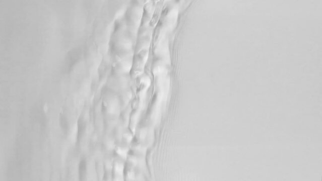 Close up view on Water texture with waves on the water overlay effect for video mockup. Organic light gray drop shadow caustic effect with wave refraction of light. Slow motion full HD video banner.