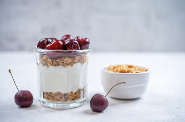 Cherry Greek yogurt granola parfait in a glass