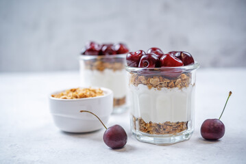 Cherry Greek yogurt granola parfait in a glass
