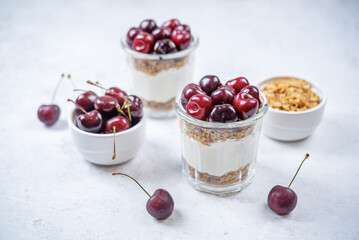 Cherry Greek yogurt granola parfait in a glass