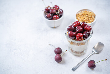 Cherry Greek yogurt granola parfait in a glass
