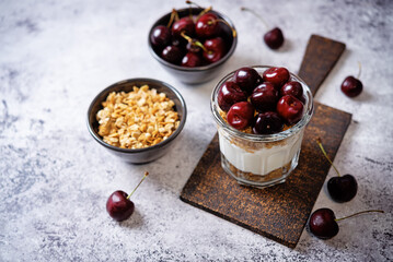 Cherry Greek yogurt granola parfait in a glass