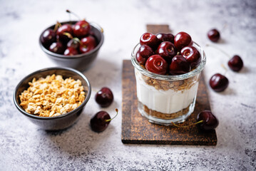 Cherry Greek yogurt granola parfait in a glass