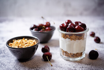Cherry Greek yogurt granola parfait in a glass