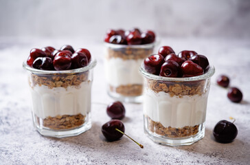 Cherry Greek yogurt granola parfait in a glass