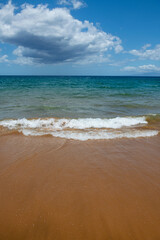 Beach background. Calm beautiful ocean wave on sandy beach. Sea view from tropical sea beach.