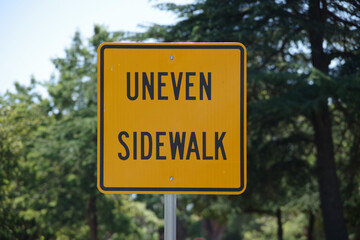 Warning sign UNEVEN SIDEWALK