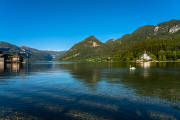 Stunning panorama view of Grundlsee lake with mountain peaks of Styrian Alps in background on a sunny summer day, Ausseerland - Salzkammergut region, Styria, Austria - 518848496