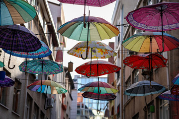 Fototapeta na wymiar umbrellas in the street with bokeh / Kadıköy