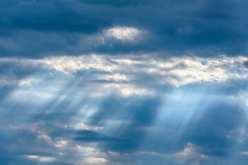 Dramatic blue sky with many rays of light