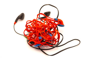 tangled various headphones on white - 518848665
