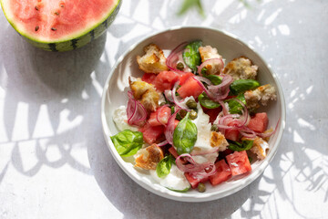 Summer salad with watermelon, buratta, basil and pickled onions