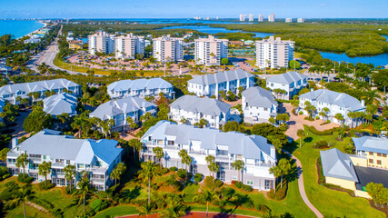 Aerial View of Real Estate in Bonita Springs, Florida with the Bay and Mangroves in the Background Drone