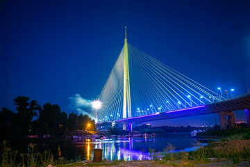 Obraz premium Ada bridge on river Sava in Belgrade Serbia nightscape with fireworks in background and marina on another bank