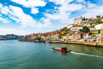 Porto, Portugal, old town cityscape and the Douro River with traditional Rabelo boats, seen from the Dom Lusi bridge
