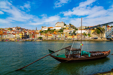 Porto, Portugal, old town cityscape and the Douro River with traditional Rabelo boats