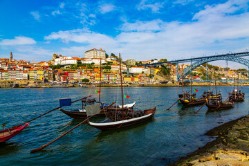 Porto, Portugal, Riberia old town cityscape with Dom Lusi bridge and the Douro River with traditional Rabelo boats