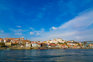Fototapeta na wymiar Porto, Portugal, Riberia old town cityscape with colorful houses, Dom Luis bridge, seen form Douro River