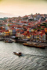 Fototapeta na wymiar Porto, Portugal, old town cityscape and the Douro River with traditional Rabelo boats, seen from the Dom Luis bridge