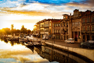Obraz premium Aveiro, Portugal, Moliceiro boats docked along the central city canal during sunset