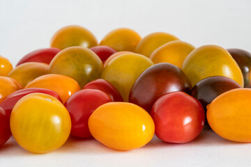 Close-up of a group of cherry tomatoes of different colours, yellow, green, black and red