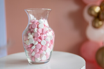 Pink and white sweets in a jar
