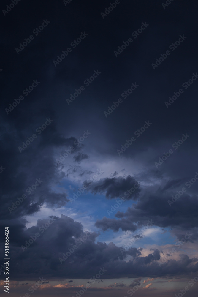 Wall mural epic dramatic storm dark grey cumulus rain clouds against blue sky background texture, thunderstorm