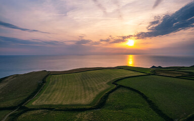 Sunset over Fields and Farms of Caunter Beach and Cliffs, Hartland Cornwall Heritage Coast, South...