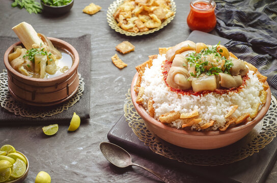 Arabic cuisine; Egyptian oriental Fattah with white rice and crispy bread topped with seasoned garlic red sauce and chunks of cow's trotters. Served with traditional cow's trotters soup.