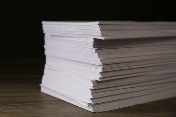 Stack of paper sheets on wooden table, closeup