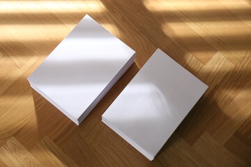 Stacks of paper sheets on wooden table, above view