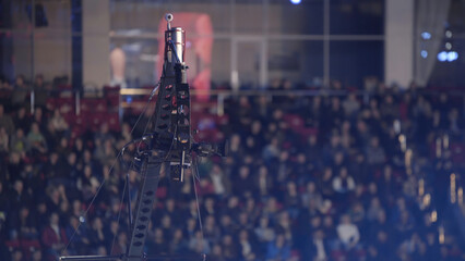 Video camera on a crane at concert, equipment film. camera record on crane in production on studio and light to stage for entertainment industry. TV camera on a crane, football mach or concert