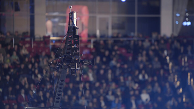 Video camera on a crane at concert, equipment film. camera record on crane in production on studio and light to stage for entertainment industry. TV camera on a crane, football mach or concert