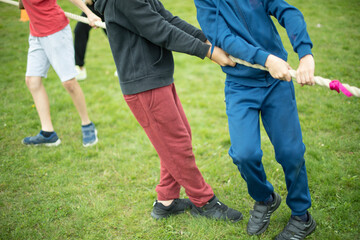 Children are pulling rope. Sports game. Schoolboy pulls rope.