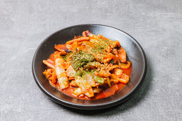 Korean food Stir-fried Squid, ojingeobokkeum : Squid stir-fried with onions, carrots, and cabbage in a spicy mixture of gochujang and red chili powder.