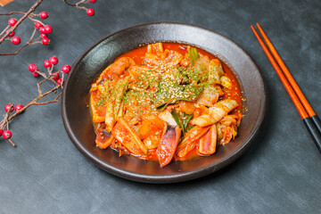 Korean food Stir-fried Squid, ojingeobokkeum : Squid stir-fried with onions, carrots, and cabbage in a spicy mixture of gochujang and red chili powder.