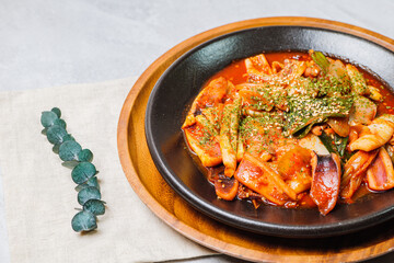 Korean food Stir-fried Squid, ojingeobokkeum : Squid stir-fried with onions, carrots, and cabbage in a spicy mixture of gochujang and red chili powder.