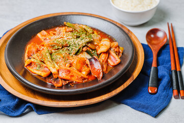 Korean food Stir-fried Squid, ojingeobokkeum : Squid stir-fried with onions, carrots, and cabbage in a spicy mixture of gochujang and red chili powder.