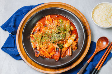 Korean food Stir-fried Squid, ojingeobokkeum : Squid stir-fried with onions, carrots, and cabbage in a spicy mixture of gochujang and red chili powder.